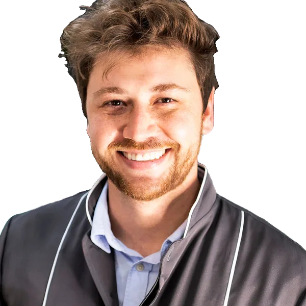 Dr. Pablo Navarro, ortodoncista de Clínica Velia, con chaqueta clínica gris